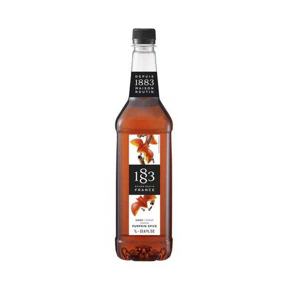 1883 Maison Routin Pumpkin Spice Syrup 1L bottle with orange liquid, black cap, and autumn leaf label.