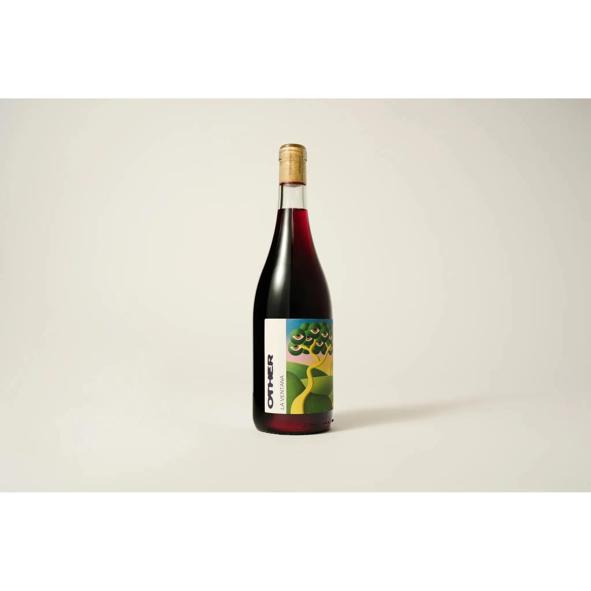 Other World Wine La Ventana, a dark red wine bottle with a colorful, abstract landscape label and cork stopper.