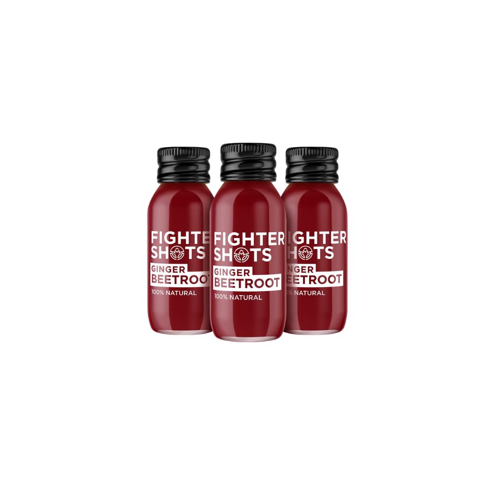 Three small, dark red "Fighter Shots" ginger and beetroot bottles with black caps.