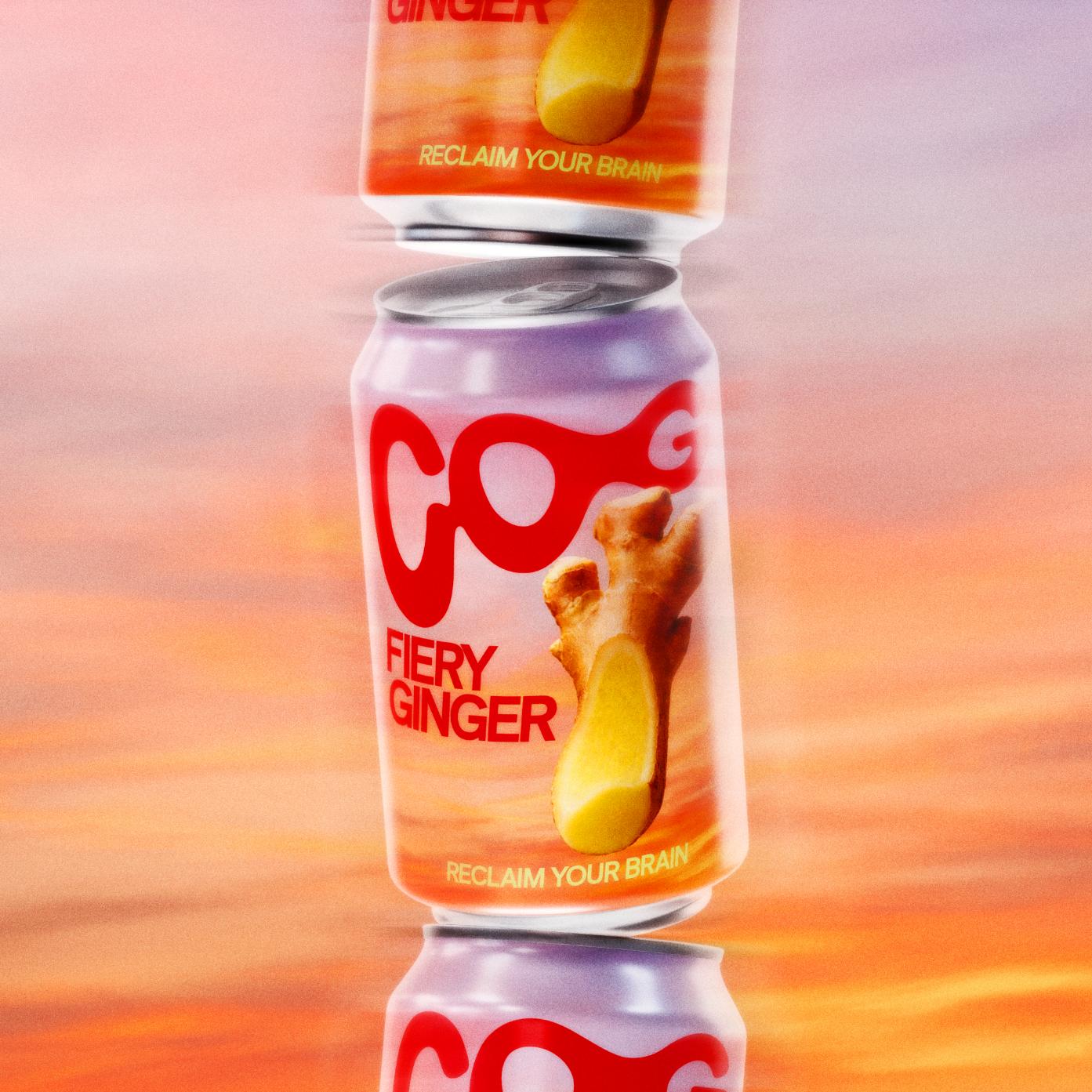 Stack of three COG Fiery Ginger soda cans with purple and orange labels, featuring ginger root.