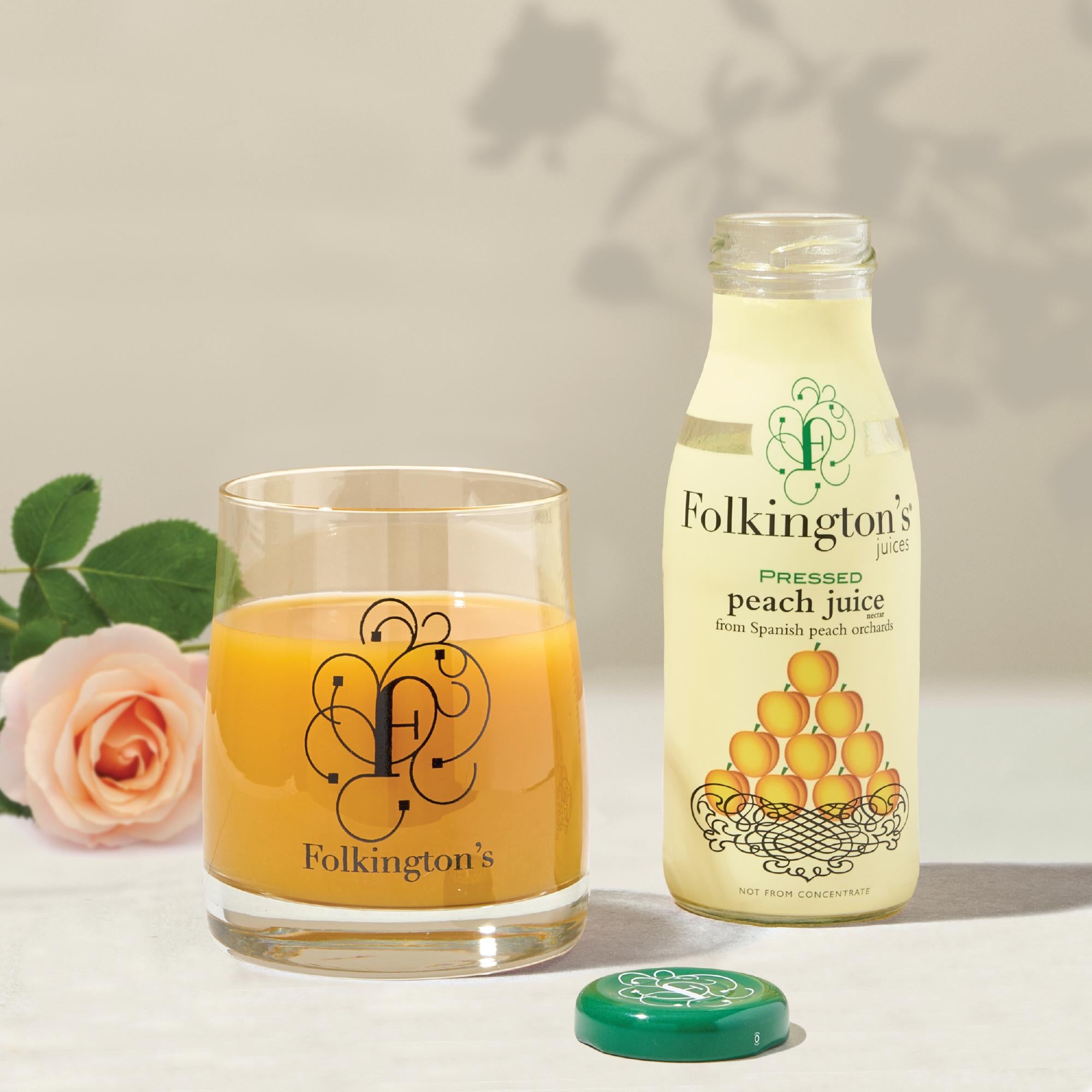 Folkington's Pressed Peach Juice bottle and glass, with a pink rose and green cap.
