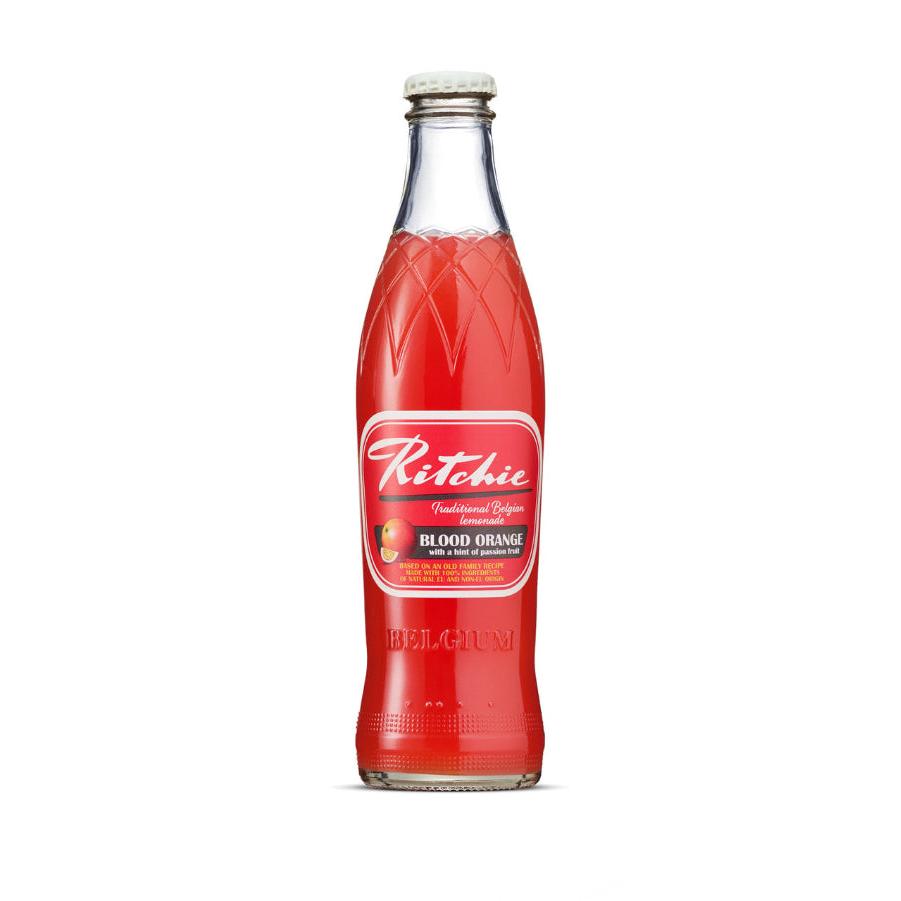 Ritchie Blood Orange soft drink in a clear glass bottle with a white twist-off cap and red label.