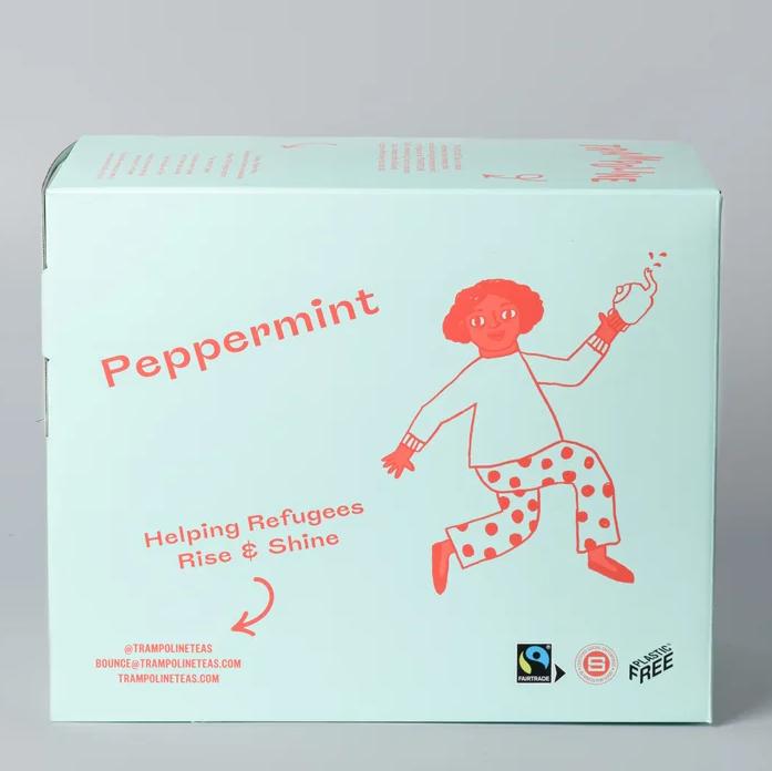Light blue box of Trampoline Peppermint Tea with a red cartoon figure, "Helping Refugees Rise & Shine" text, and Fairtrade logo.