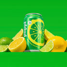 Poppi Lemon & Lime soda can, green with a yellow citrus slice design, surrounded by fresh lemons and limes.