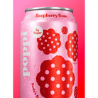 Close-up of a condensation-covered pink Poppi Raspberry Rose soda can with red floral designs and "5g Sugar.