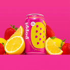Poppi Strawberry Lemon soda can, pink with yellow polka dots, surrounded by fresh strawberries and lemon slices.
