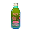 Green glass Yugen Kombucha Grapefruit Hops bottle with pink and white label, gold cap.