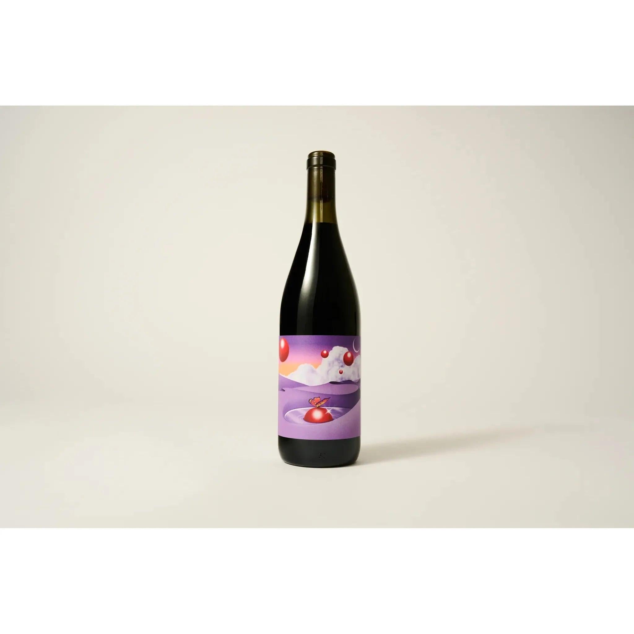 Dark red wine bottle with a vibrant purple label featuring an abstract landscape and red floating spheres.
