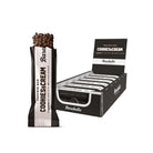 Barebells Cookies & Cream protein bar, dark chocolate with cookie crispies, next to a black display box of 12 bars.
