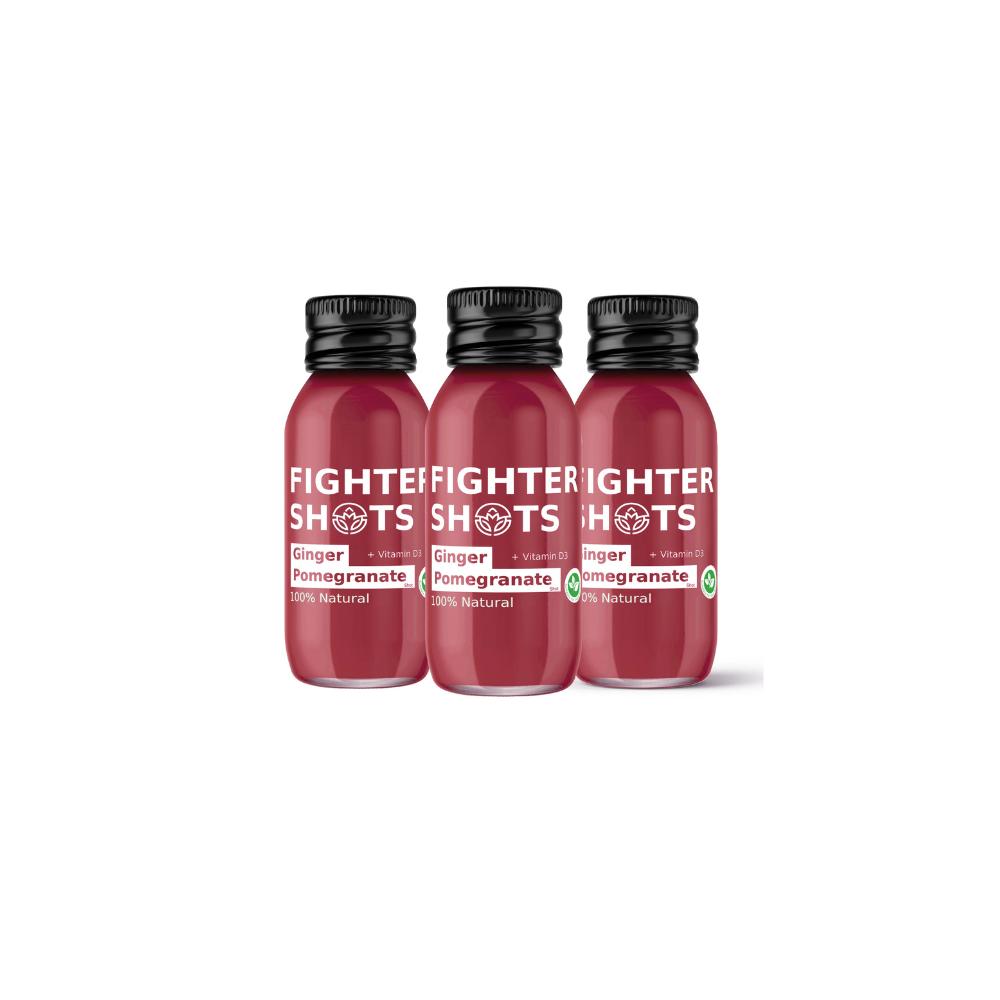 Three small, dark red Fighter Shot bottles with black caps, labeled Ginger & Pomegranate + Vitamin D3.