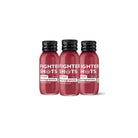 Three small, dark red Fighter Shot bottles with black caps, labeled Ginger & Pomegranate + Vitamin D3.