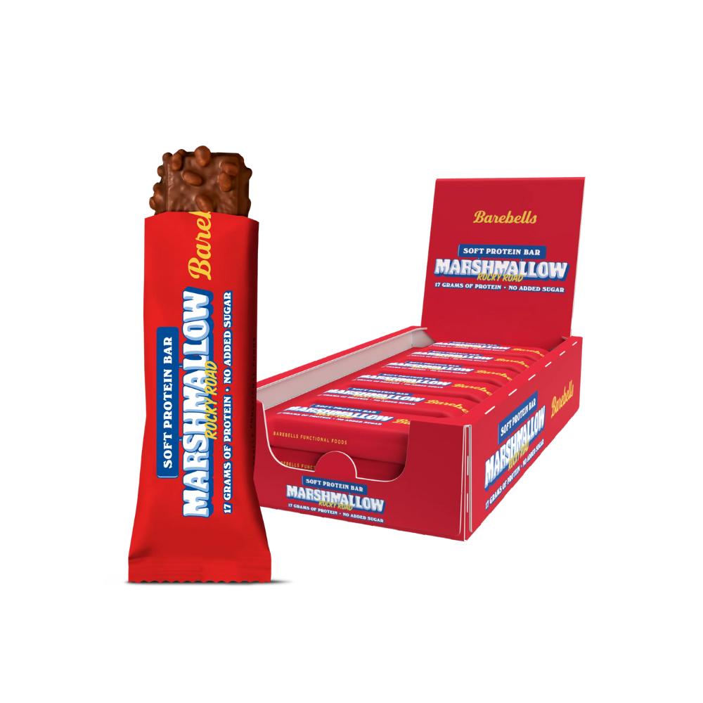 Barebells Rocky Road Marshmallow Soft Protein Bar, unwrapped, next to a red display box of 12 bars.