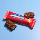 Barebells Rocky Road protein bar in red wrapper with two chocolate-coated bars, one bitten, showing marshmallow and caramel.