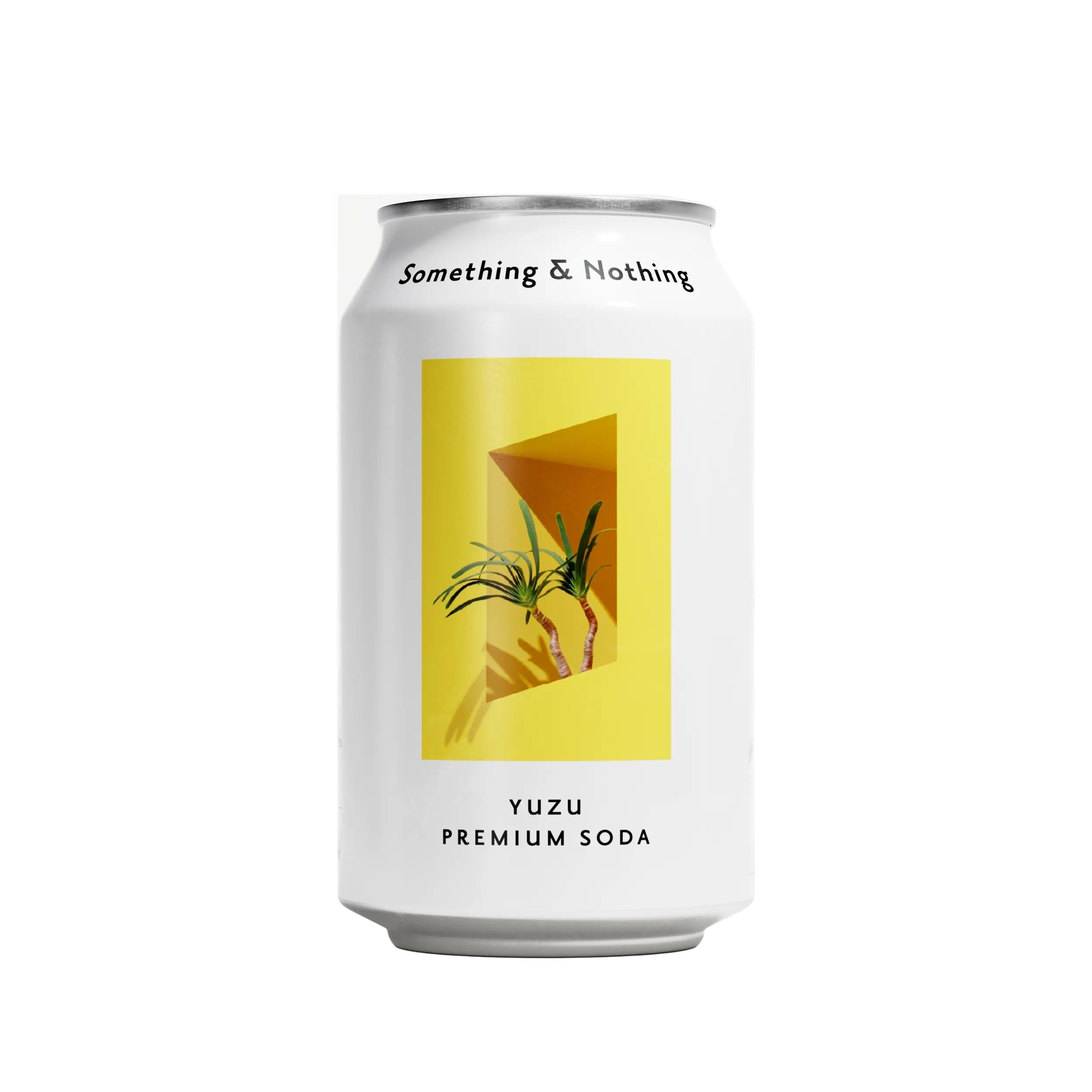 White Something & Nothing Yuzu Premium Soda can with a yellow geometric design and green plant illustration.