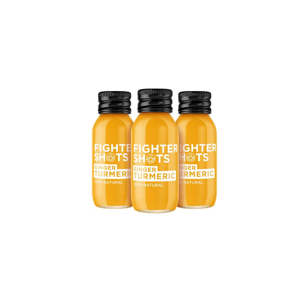 Three small orange Ginger & Turmeric Fighter Shots bottles with black caps and white labels.