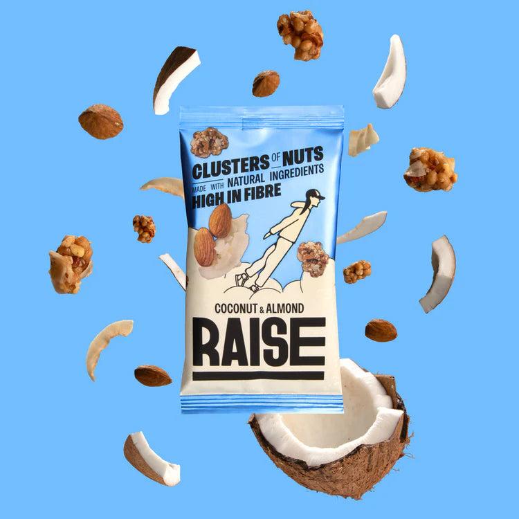 Raise Snacks Coconut & Almond pouch with nuts, coconut pieces, and almonds scattered on a blue background.