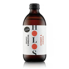 Holos Ginger & Hibiscus Organic Kombucha in a cold, condensation-covered brown glass bottle with white label.