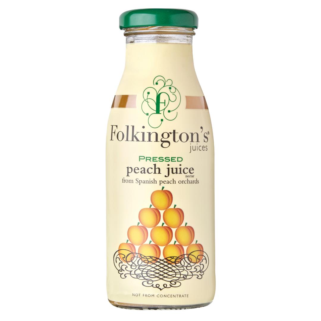 Folkington's Pressed Peach Juice in a clear glass bottle with a green cap and peach label design.