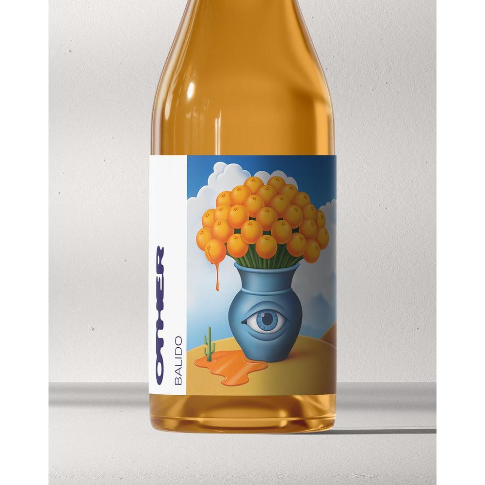 Balido orange wine bottle with a surreal label featuring a blue vase with an eye, holding oranges.