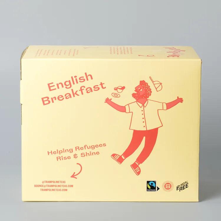 Trampoline English Breakfast tea box, light yellow with red text and a joyful cartoon figure. Organic, Fairtrade, Plastic-Free.