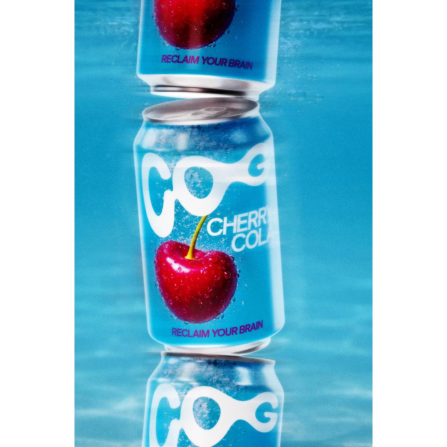 Three blue COG Cherry Cola cans with a red cherry, "RECLAIM YOUR BRAIN" text, partially submerged in water.