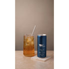 Marna Lemon Iced Tea in a wet blue can next to a glass of iced tea with a straw.
