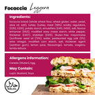 Two halves of a Leggera Focaccia sandwich with turkey, egg mayo, tomato, oregano, and lamb's lettuce.