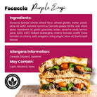 Vegan focaccia sandwich with fried aubergine, roasted tomato hummus, cherry tomatoes, and fresh basil.