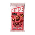Pink Raise Snacks pouch with "Raspberry & Roasted Almond" nut clusters, natural ingredients.