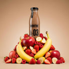 Berry Boost Smoothie bottle surrounded by fresh red apples, strawberries, raspberries, and bananas.