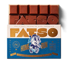 Fatso Home Run dark chocolate bar with "FATSO" molded on top, in blue and white baseball-themed packaging.