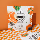 Blendsmiths House Chocolate 2kg bag with orange and leaf design on a checkered table.