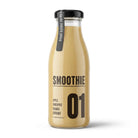 Glass bottle of creamy tropical apple, pineapple, banana, and coconut smoothie with black label and cap.