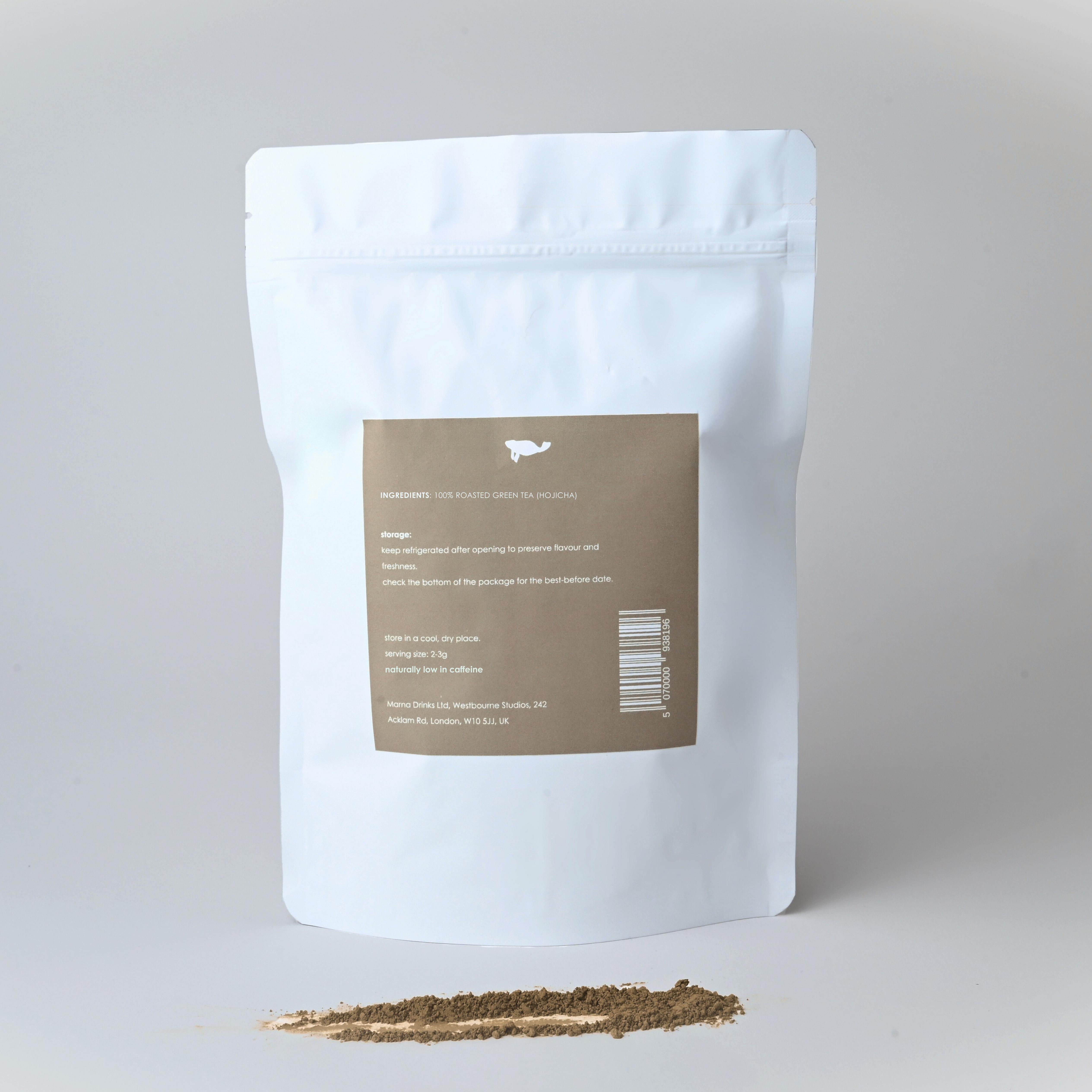 White Marna Hojicha 250gm pouch with brown label, roasted green tea powder spilled in front.