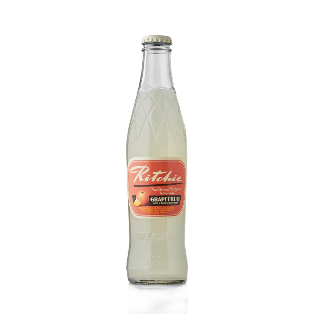 Ritchie Grapefruit & Pineapple lemonade in a clear glass bottle with a red and orange label.