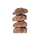Stack of four YuBi Gateau Protein Bar halves, showing dark chocolate coating, brown base, and red cherry caramel filling.