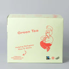Light green box of Trampoline Green Tea, featuring a red cartoon character and "Helping Refugees Rise & Shine.