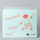 Light blue box of Trampoline Peppermint Tea with a red cartoon figure, "Helping Refugees Rise & Shine" text, and Fairtrade logo.