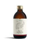 YOU + I Black Cherry Kombucha in a 330ml amber glass bottle with a gold cap and cherry branch label.