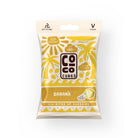White pouch of Coco Cubes Banana snack with yellow palm trees, sun, and waves design.