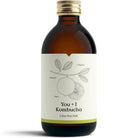 Amber glass bottle of YOU + I Lime Sea Salt Kombucha with a white label featuring a lime illustration and gold cap.