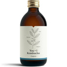 Amber glass bottle of YOU + I Original Kombucha with a gold cap and a minimalist white label featuring a leaf design.