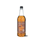 Sweetbird 1l glass bottle of golden salted caramel syrup with a black cap.