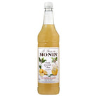 Monin Cloudy Lemonade Base 1L syrup in a clear glass bottle with a white cap and yellow label.
